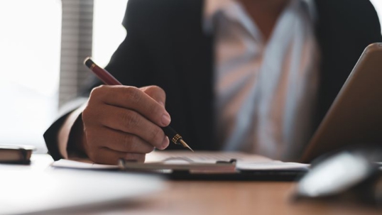 A probate attorney takes notes on courtroom proceedings