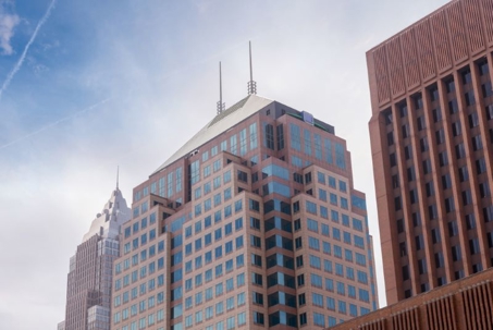 An image of three tall buildings in a city.