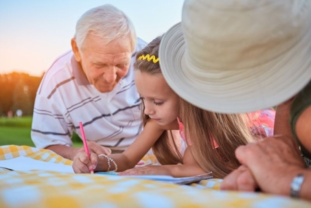 grandparents and child outside.